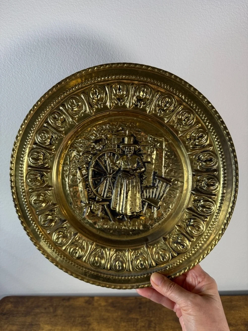 Decorative Embossed Brass Wall Plate with Spinning Wheel Motif
